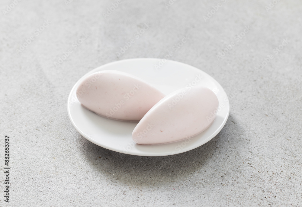 Vanilla Strawberry cream quenelle, on a plate. Close up	