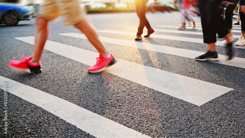 Group of people walking on the crosswalk at sunset