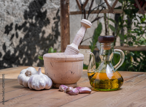 olive oil with morter, pestle and garlic
