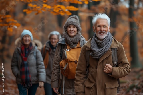 Happy senior hikers in an autumn forest