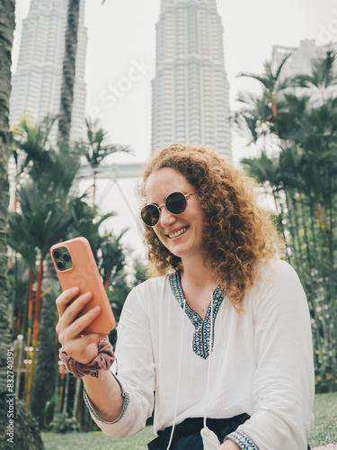 Photography Woman Video Calling with Smartphone in Kuala Lumpur Urban Park