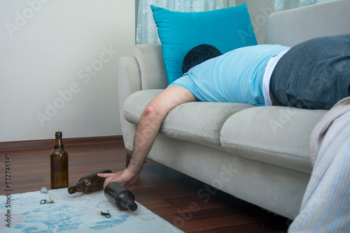 Φωτογραφία Man passed out due to alcohol is sleeping on the sofa