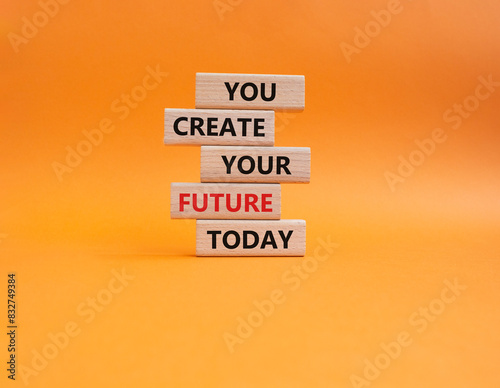 Future and development symbol. Wooden blocks with words You Create your Future today. Beautiful orange background. Business and Future and development concept. Copy space.