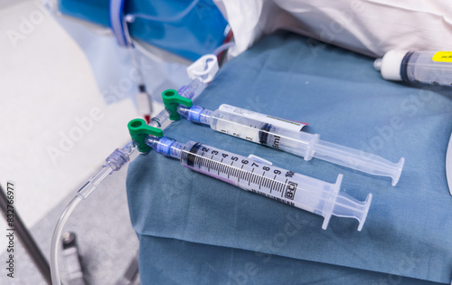 medical syringes with anesthetic drugs - propofol, midazolam, fentanyl - arranged on sterile tray in hospital setting