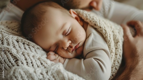 Newborn Photos. Cute Baby Boy Sleeping in Father's Arms with Love and Joy