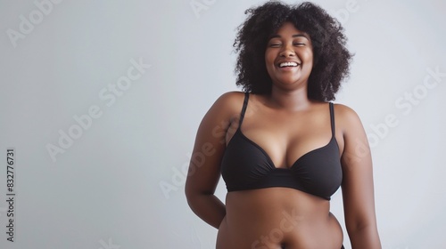 Self acceptance. Body positive overweight afro-american woman accepts herself stands dressed in comfortable underwear on a plain background. Lifestyle and weight loss. Plus size black girl