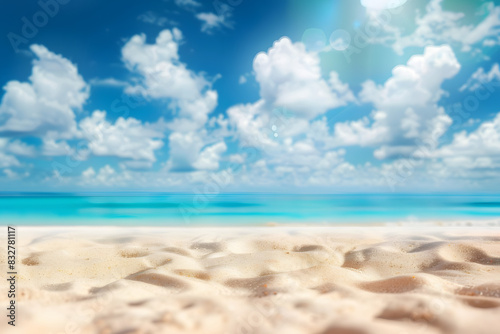 Abstract blur defocused background. Tropical summer beach with golden sand  turquoise ocean and blue sky with white clouds on bright sunny day. Colorful landscape for summer holidays.