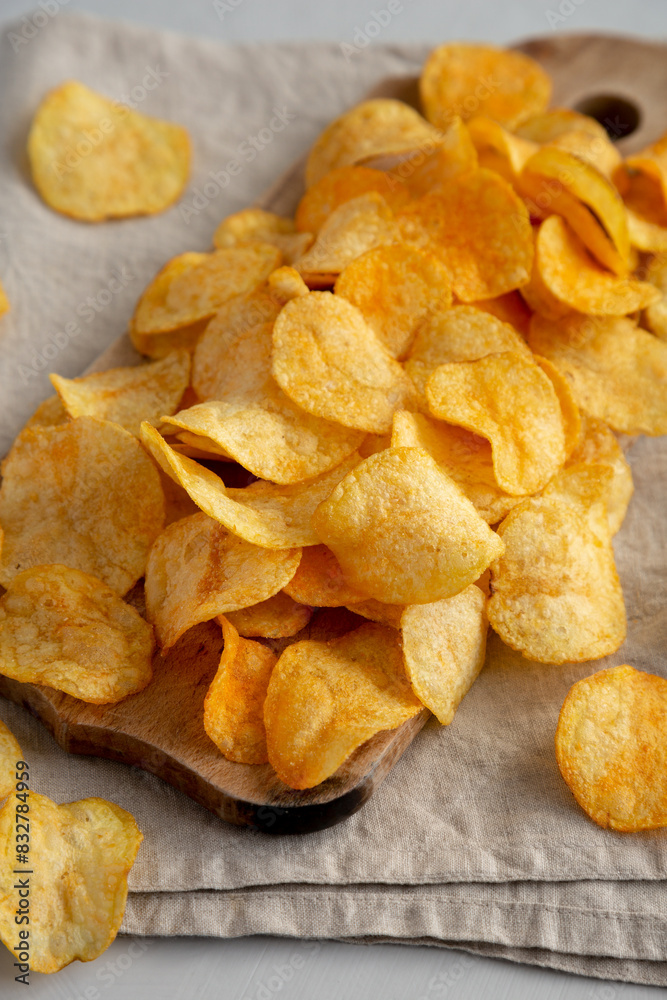 Cheese Potato Chips on a Wooden Board, side view. Cheese Potato Chips on a Wooden Board, side view.