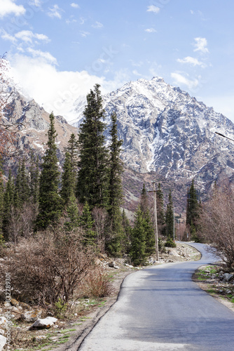 High rocky mountains with snow in spring day. Natural landscape in Ala-Archa National Park. Kyrgyzstan, Tian-Shan.
