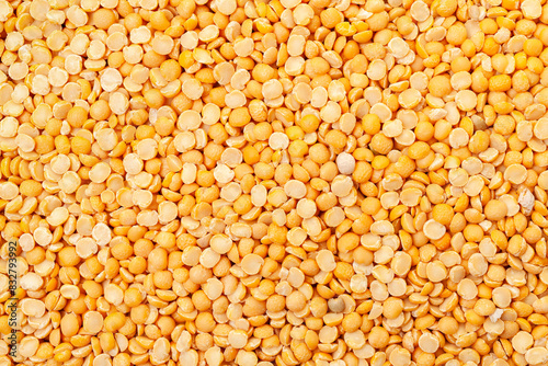 Uncooked, split, yellow peas background. Dry peas grains. Top view