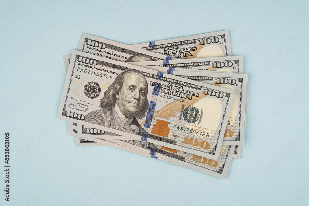 100 dollar bills on a blue background 100 dollar bills on a blue background