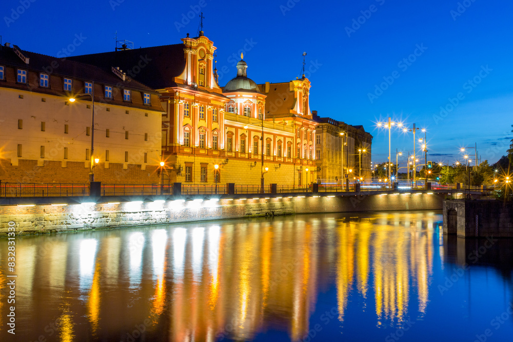 Twilight illumination of baroque church by the river