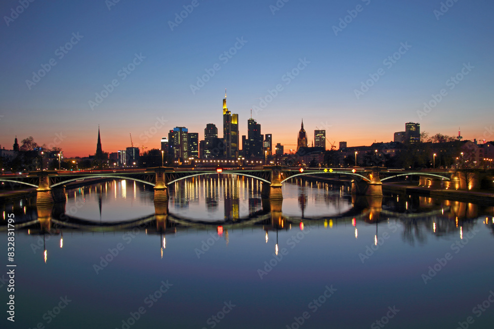 Sunset skyline of frankfurt with illuminated bridges
