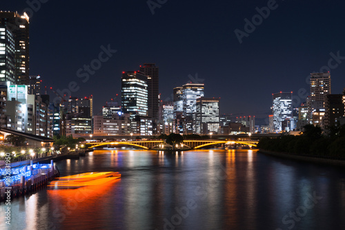 Illuminated cityscape at night with riverfront view