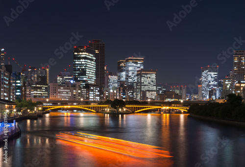 Urban nightscape with river and illuminated buildings