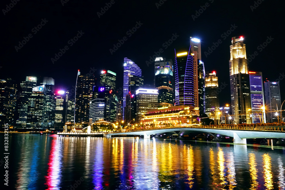 Vibrant city skyline at night reflecting on water