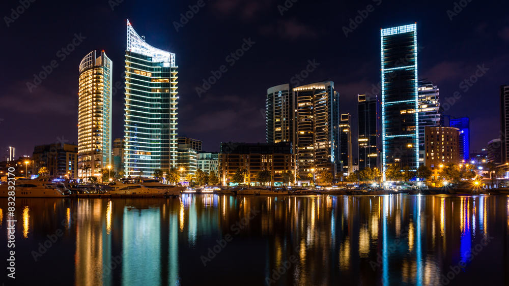Urban reflections: nighttime cityscape with illuminated skyscrapers