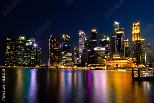 Vibrant cityscape at night with waterfront reflections