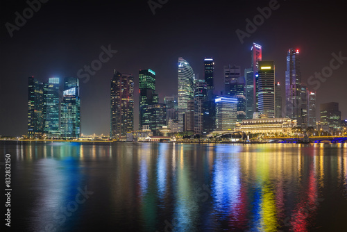 Majestic city skyline at night with reflective waterfront