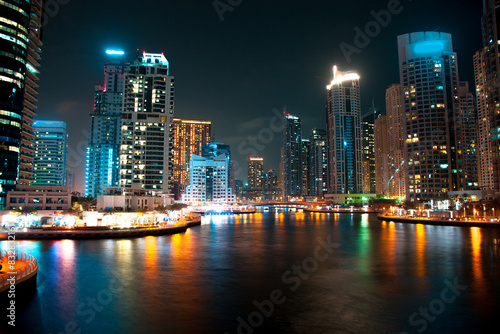 Dazzling urban nightscape reflecting on waterfront