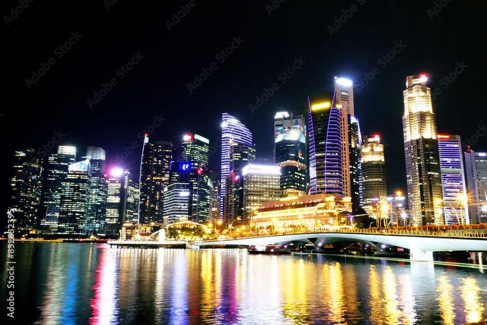 Vibrant city skyline at night by the waterfront