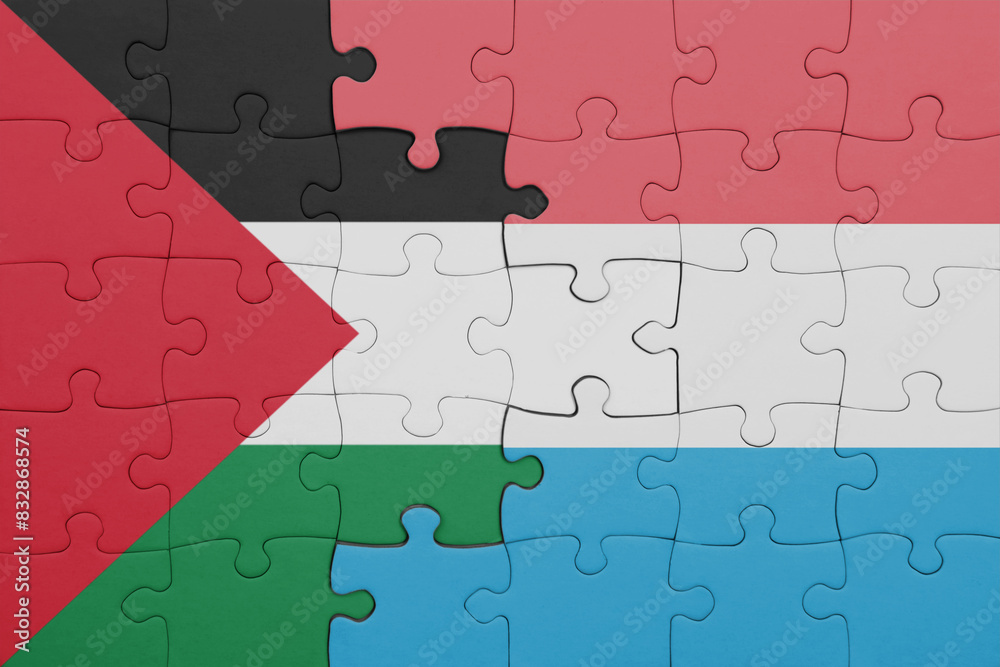 puzzle with the colourful national flag of luxembourg and flag of palestine. puzzle with the colourful national flag of luxembourg and flag of palestine.