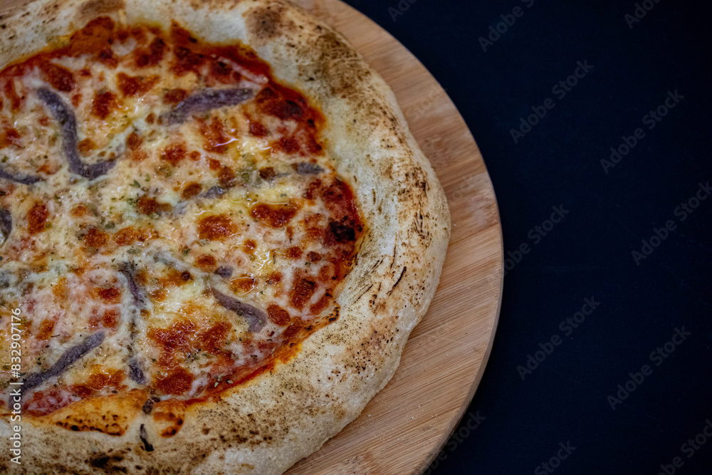 Traditional alicci or anchovy pizza, isolated in selective focus