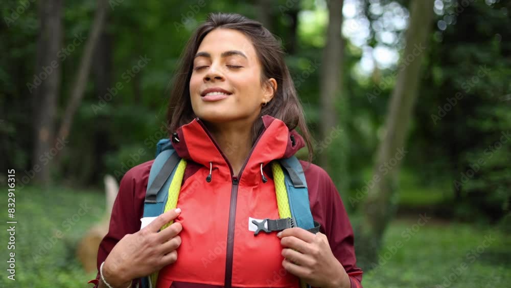 Young woman hiking in the forest and enjoying Young woman hiking in the forest and enjoying