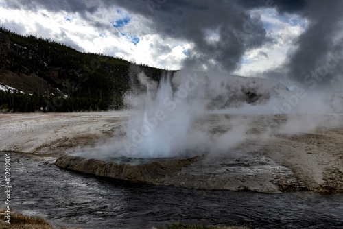 Water surface with a geyser erupting nearby