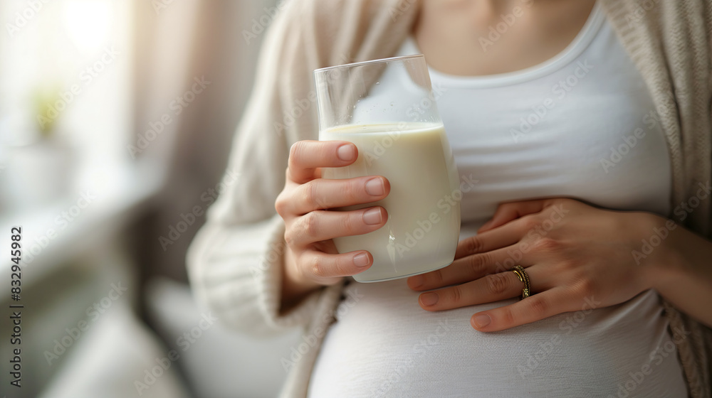 close-up of a pregnant female holding a glass of milk close-up of a pregnant female holding a glass of milk