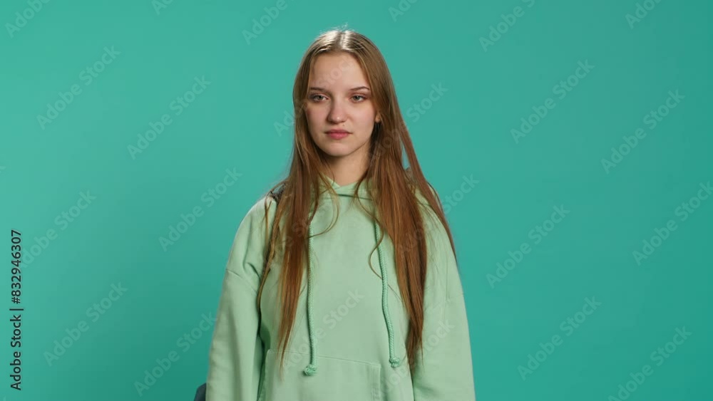 Frustrated woman showing thumbs down sign gesturing, disapproving and offering negative feedback. Disappointed girl doing dislike hand gesture, studio background, camera A Frustrated woman showing thumbs down sign gesturing, disapproving and offering negative feedback. Disappointed girl doing dislike hand gesture, studio background, camera A