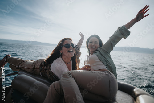 Two adult friends laugh and bond on a relaxing boat trip, embodying a spirit of carefree enjoyment during a holiday.