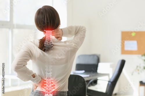 Bild auf Leinwand Young businesswoman suffering from back pain in office