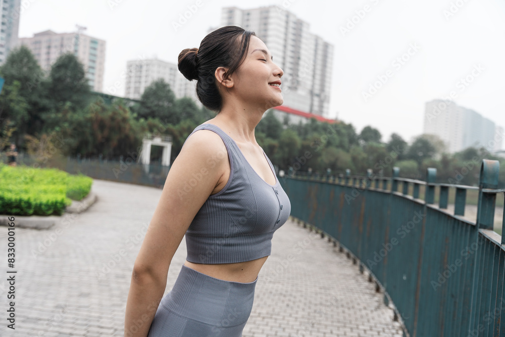 Fototapeta premium Portrait of Asian girl exercising at the park