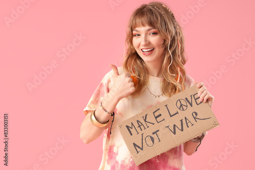 Female hippie holding placa...