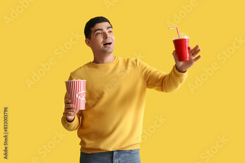Happy young man with popcor...