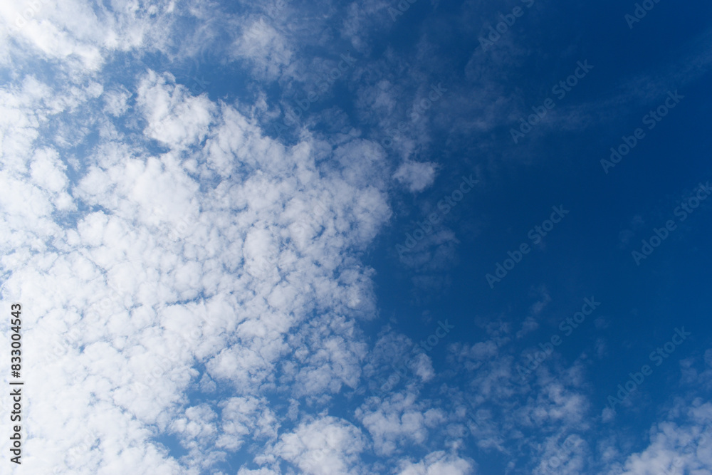 beautiful blue sky and white fluffy group of clouds with sunrise in the morning, natural background