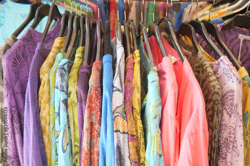 A store with a chic and neat shopping experience featuring stylish clothing on display A store with a chic and neat shopping experience featuring stylish clothing on display