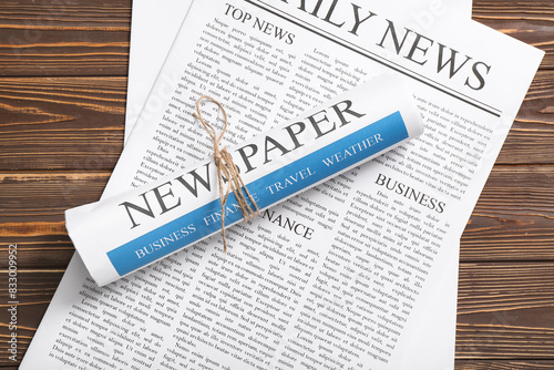 Daily newspapers on wooden ...