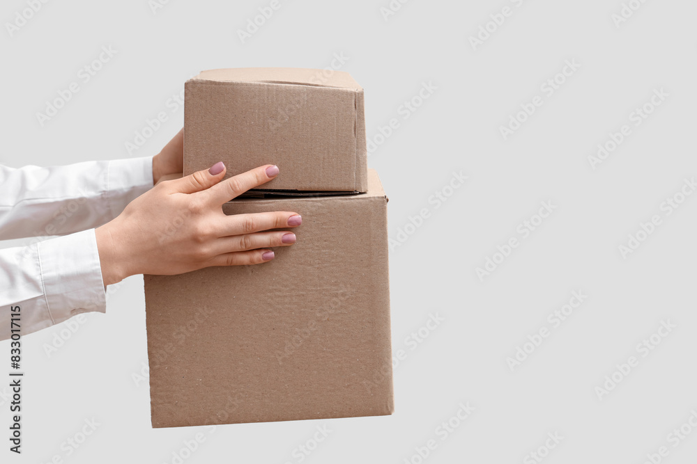 Woman holding cardboard packages on white background Woman holding cardboard packages on white background