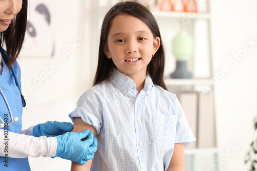 Little Asian girl with doct...