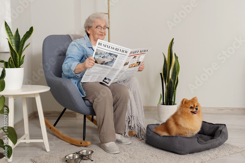 Senior woman reading newspa...