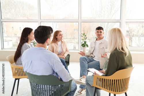 Young man talking at group ...
