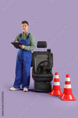 Teenage worker writing in c...