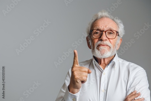Happy older senior business man wearing shirt pointing finger up on grey background, Generative AI 