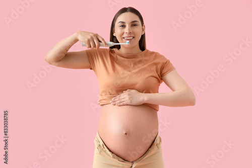 Young pregnant woman brushi...