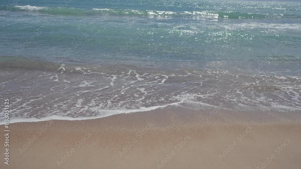 A serene beach scene with gentle waves, clear sky, tranquil sea, and soft sand under sunshine. A serene beach scene with gentle waves, clear sky, tranquil sea, and soft sand under sunshine.