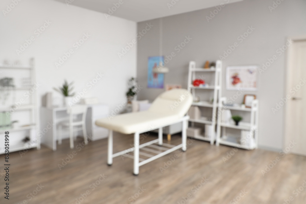 Blurred view of medical office with couch, doctor's workplace and sofa Blurred view of medical office with couch, doctor's workplace and sofa