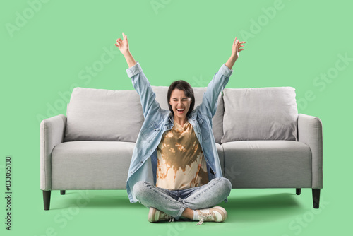 Very happy young woman sitt...