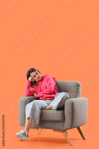Thoughtful young woman sitt...